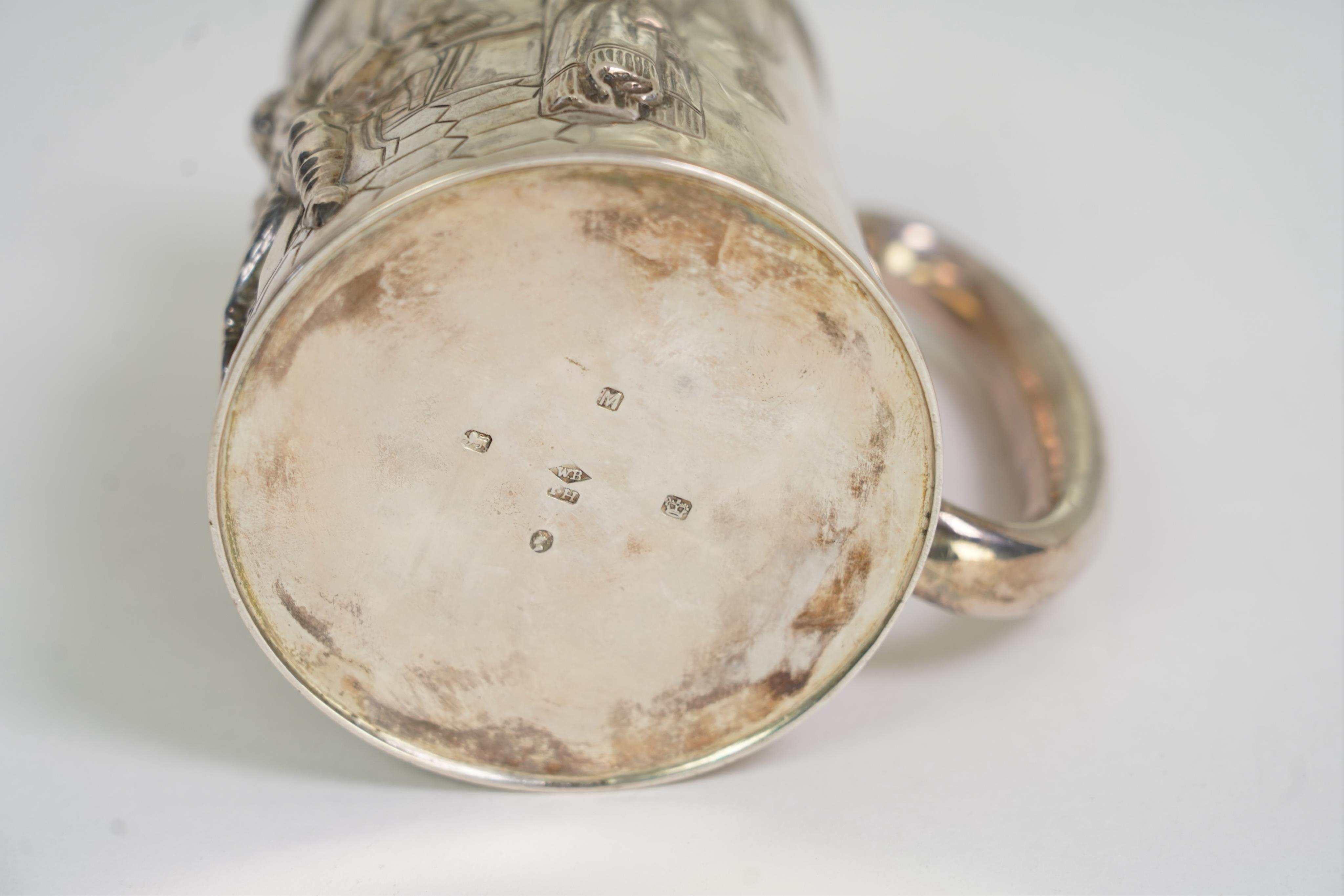 A Victorian silver mug, embossed with interior scene and imbibers, by John Harrison & Co